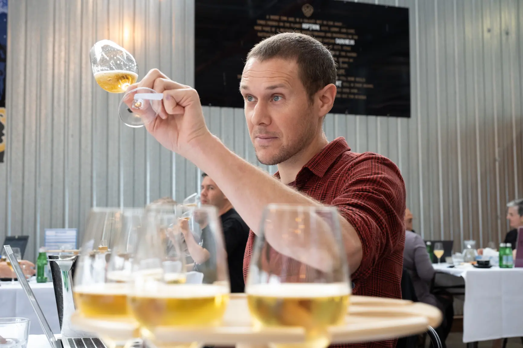 Beer judge Tom Low assesses an entry at the 2022 New World Beer and Cider Awards
